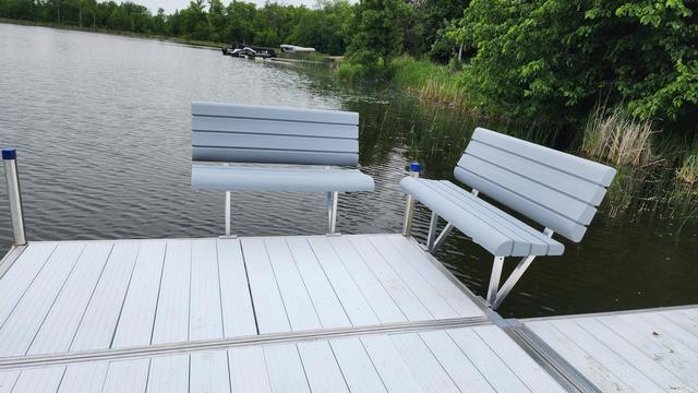 End of a dock with 2 benchs facing each other.