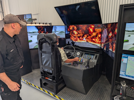 A high complexity simulator for driving a fire rescue truck at an airport. The driver is trying to manage navigation, not hitting people, operating a spray turret to manage the fire, repositioning as needed, and probably two other things.