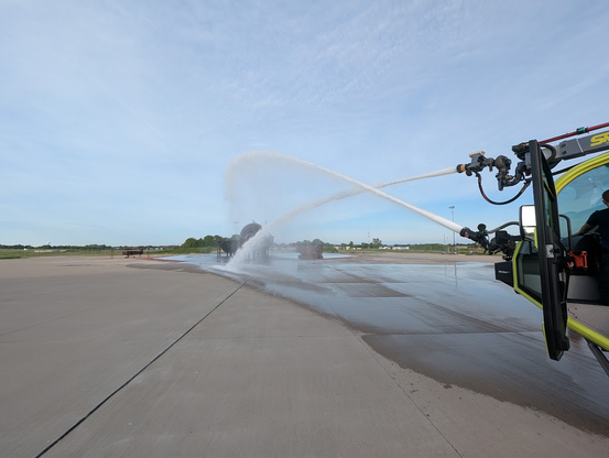The turrets on the fire vehicle spraying water showing their impressive range.