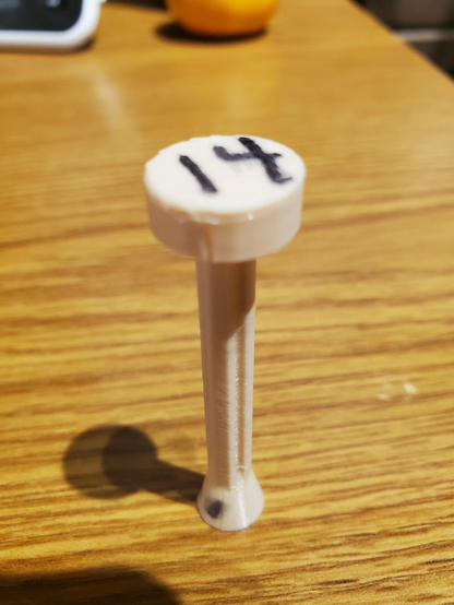 3d printed blaster dart on wood desk