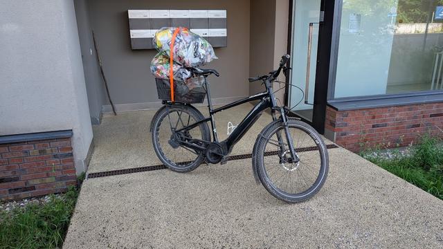 Photo of my bike with two bags full of plastic for recycling attached on top of the basket.
That stick in the corner in the back has been there for like 2 months or so. One of my kids brought it, and nobody has touched it since. Somewhat un-swiss...