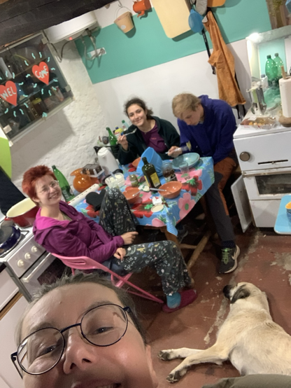 Dinner table with 3 youth & a dog