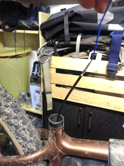 Cable housing being pulled out of seatpost with magnet.