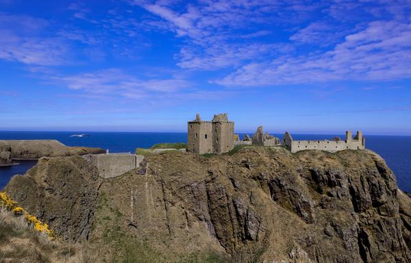 Dunottar Castle in Aberdeenshire on headland with blue skies