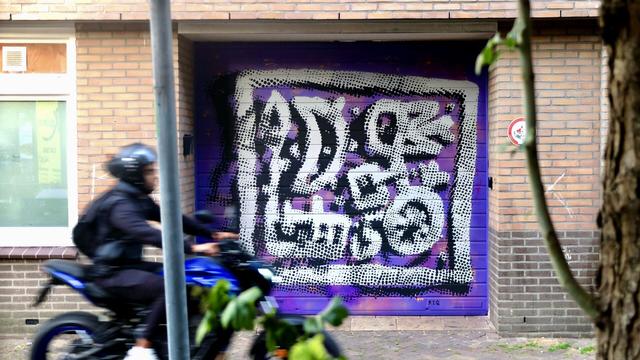 Painting on wall with motorcycle in front