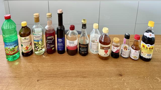 A line-up of all of our vinegar bottles on the kitchen table.