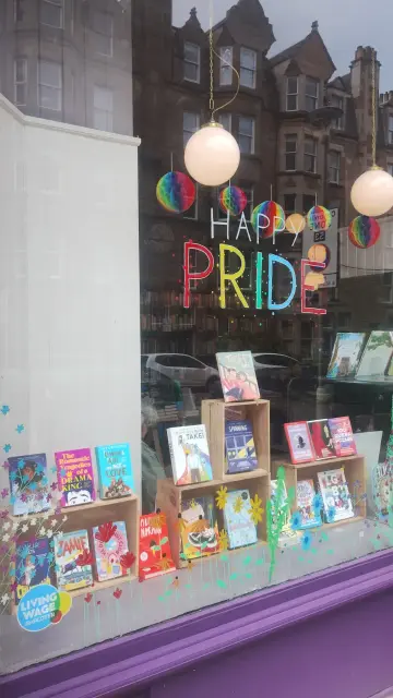 Colourful decorations and sign in the Edinburgh Bookshop's Pride Month window