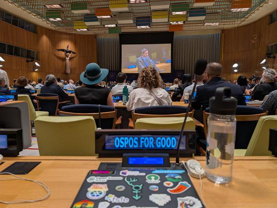 A photo of the United Nations Trusteeship Council Chamber, with Robin's laptop and water bottle on the desk in the foreground.
