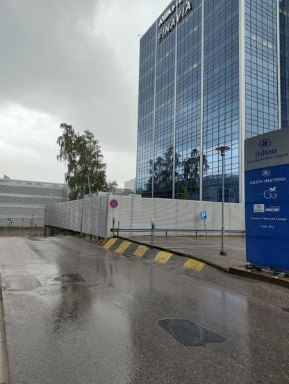 A high office building next to a parking lot