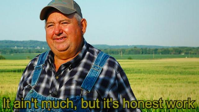 A farmer stands on field. the caption reads "It ain't much, but it's honest work"