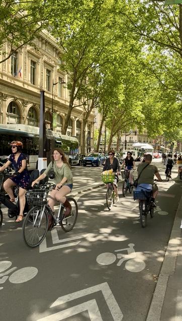 Paris protected bike-lane filled with people on bikes.
