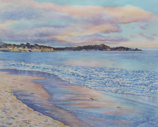 Watercolor painting of a beach at sunset. Waves gently rolling in, wet sand with reflections. Sky with clouds of pink, orange, violet. Hills and buildings in the distance.