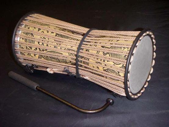 A beautiful ancient talking drum. It's body is fully decorated with traditional symbols that can be seen through the strings.