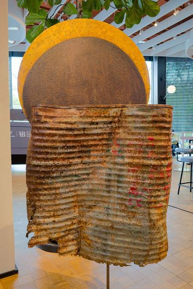 A piece of art that looks like a giant rusty food can.