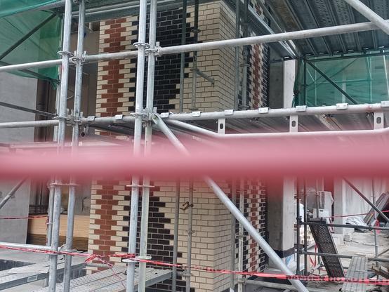 View of decorative brickwork at street level.