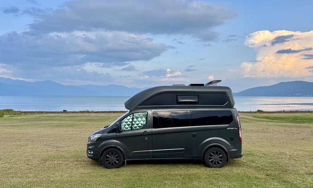 Camper van on green lawn at Lake Prespa