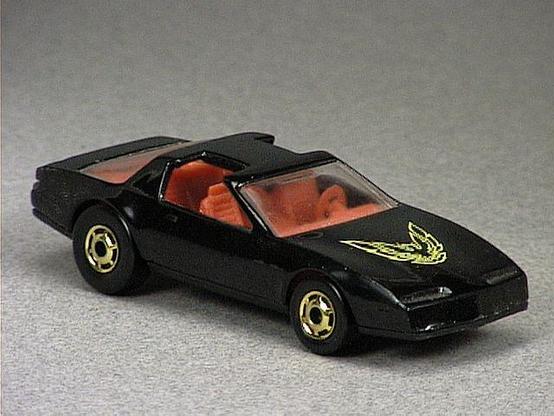 Released in 1984, Black `80's Firebird of 1984 Hot Wheels with Gold Hot Ones wheels. Notes: Based on the Pontiac Firebird. Tampo: Yellow Firebird on hood. Packaging: 1984 Blister. Metal Body, Plastic Base. Made in Hong Kong. Scarcity: 6/10