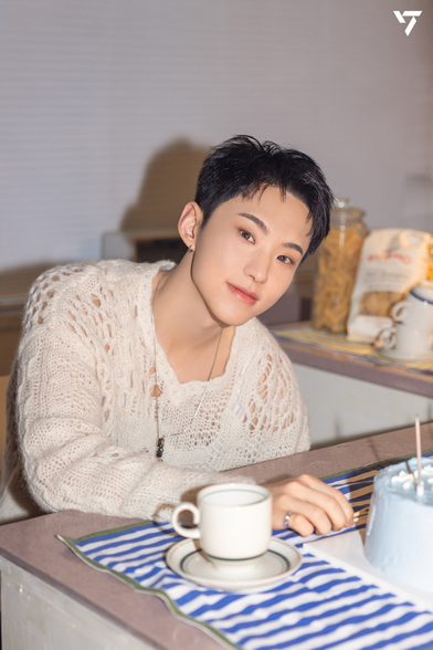 Hoshi in his birthday song shoot - fluffy white sweater, lighting a birthday cake candel, tea cup
