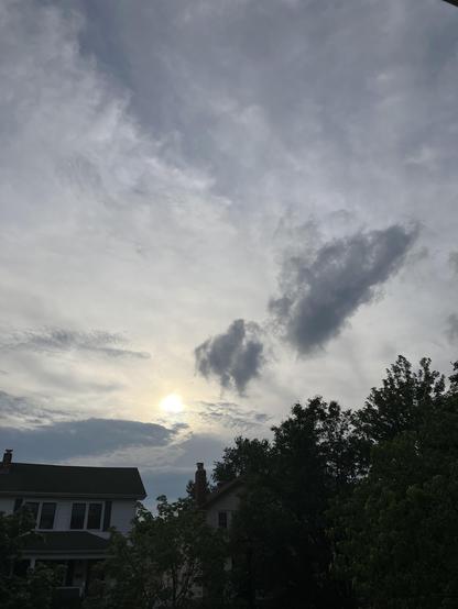 Dark clouds beginning to form over a sunset.