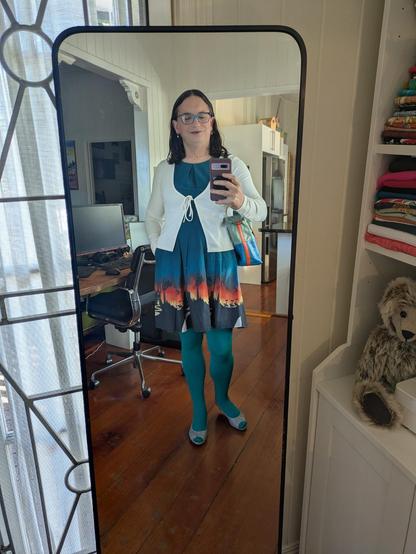 A mirror selfie of me wearing the aqua stockings outfit shown in the flat lay.