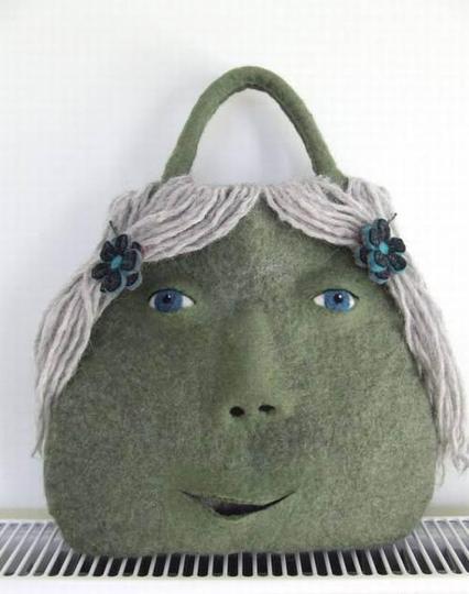 Technically it's a handbag, but its also a big, green, felt face.