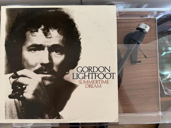 An album cover for "Summertime Dream" by Gordon Lightfoot featuring a black-and-white portrait of the artist with a thoughtful expression. A microphone is visible in the background, suggesting a music-related setting.