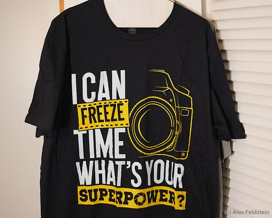 Photographer T-shirt shows a camera and says:

"I can freeze time, what's your superpower?"