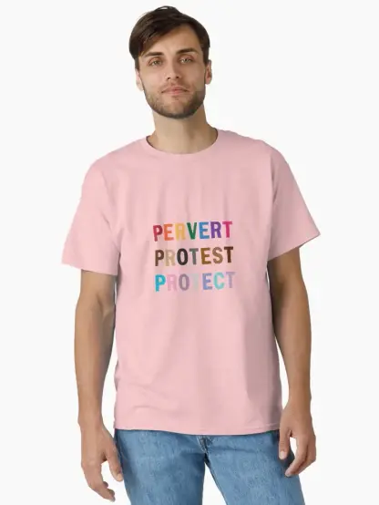a gent models a pinkish tee with my design: Pervert. Protest. Protect. the text is uppercase. letters for Pervert are rainbow colors; Protest are shades of brown; Protect are colors resembling the trans pride flag.