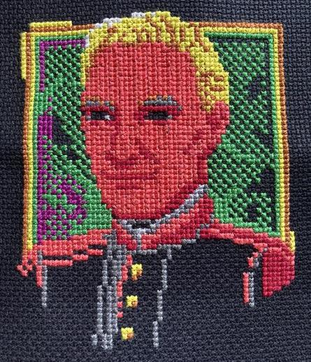My work in progress of my cross-stitch of Ranger Murdoch, a character in my game The Crimson Diamond. His eyes are empty and black and look creepy.