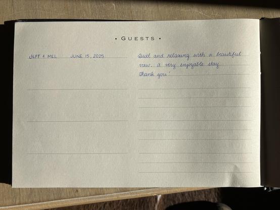 A guestbook entry written in beautiful handwriting. It reads:
“Jeff & Mel
June 15, 2025
Quiet and relaxing with a beautiful view. A very enjoyable stay. Thank you!”