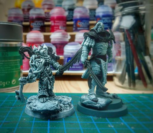 Two third party miniatures of Lucius the Eternal and Fulgrim side by side. They are primed and zenithaled and the metal parts of their armour is blacked.