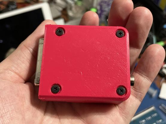 The bottom of the device has four black wafer head screws.