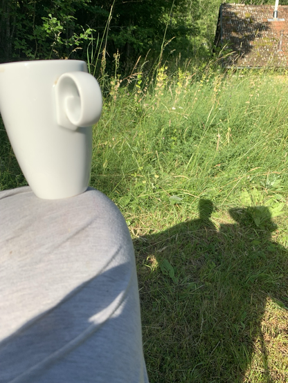 Yea cup on my knee, & shadow of it on the grass