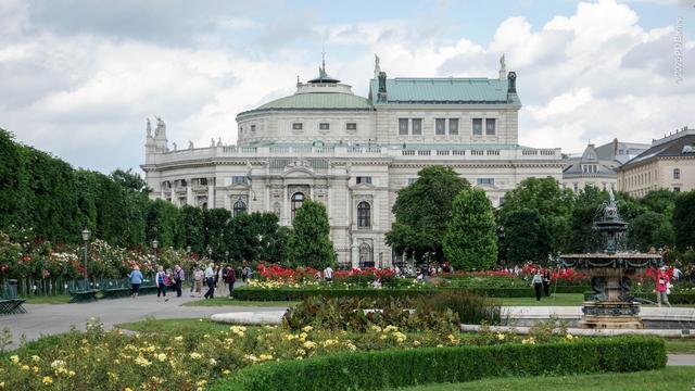 Looking across rose gardens and strolling humans to the Burgtheater, Vienna