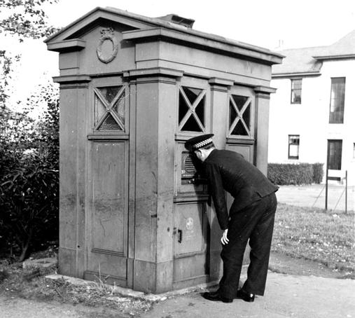 A police officer demonstrating the use of the Speakerphone unit. Opening the box door automatically connected the phone to the headquarters switchboard. Photo via Lothian & Borders Police Wordpress.