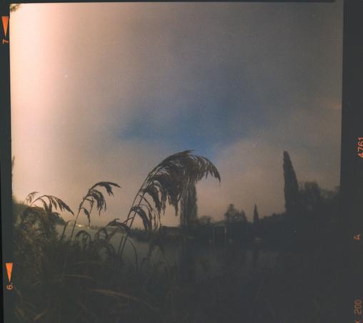 A farn in front of a lake
