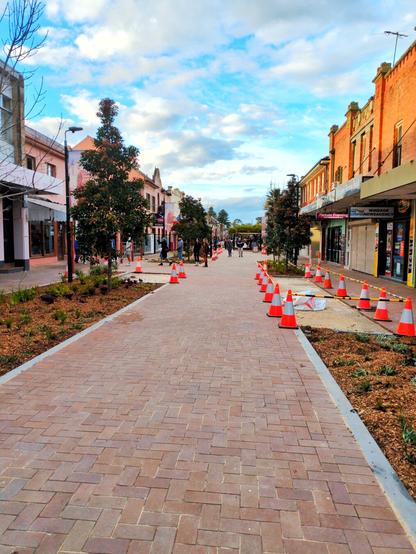 Further down the street. There's fluro orange cones out where pavers are being replaced.
