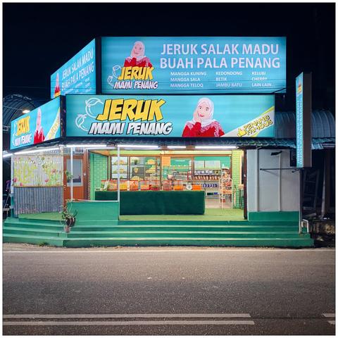 Malaysian auntie store with a lot of neon at night.