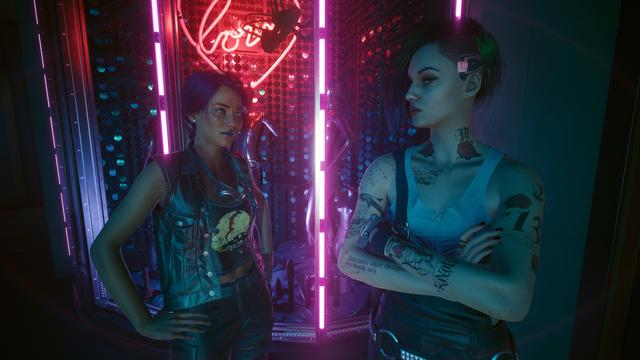 Cyberpunk 2077 screenshot player character with hands on hips and Judy with arms crossed looking at each other in front of some neon lights.