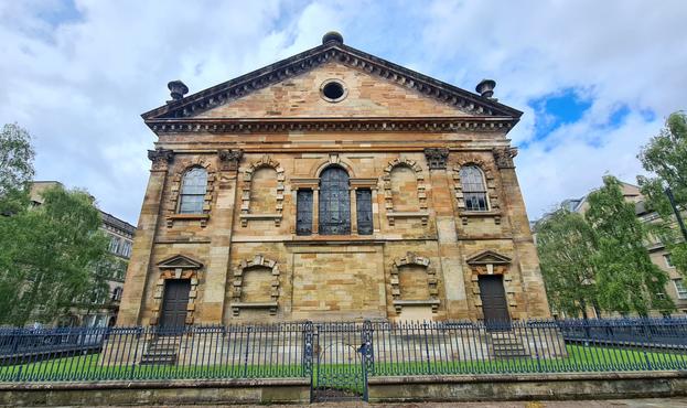 An 18th Century Church at the centre of a tree-lined square in Glasgow.