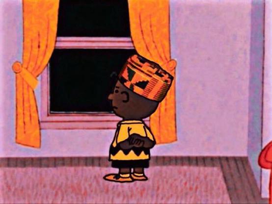 A black Charlie Brown looking out the window