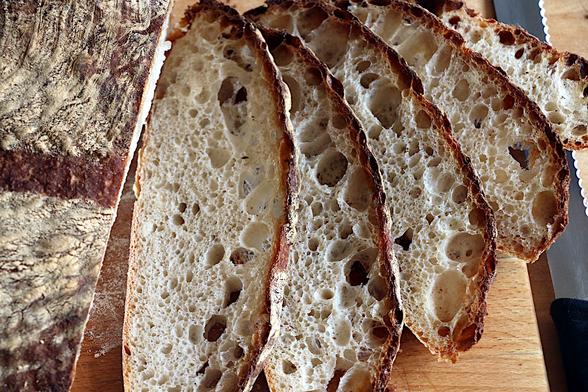 Slices of the load viewed from above showing moderately large bubbles in the crumb