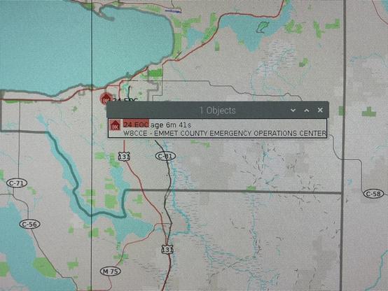 Map of the Petoskey, MI area, with an APRS object (red house icon with “EOC” in white) shown.