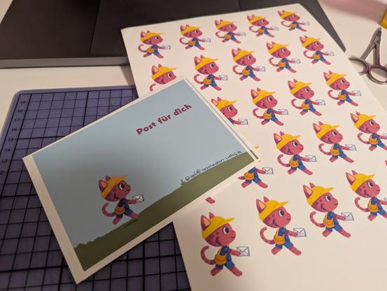 postcard with a small postman cat and a sticker sheet with the same cat