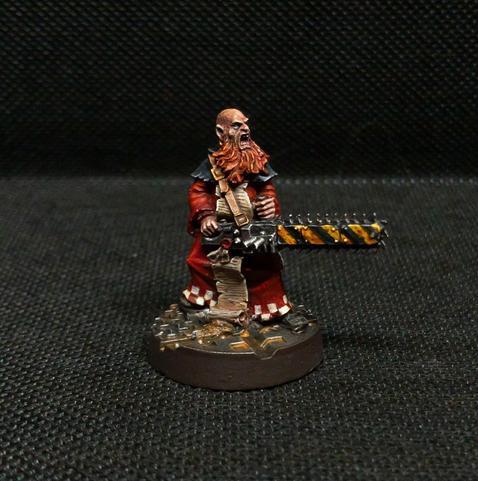 an angry yelling man in red robes with a bright orange beard wielding an enormous two-handed chainsaw
