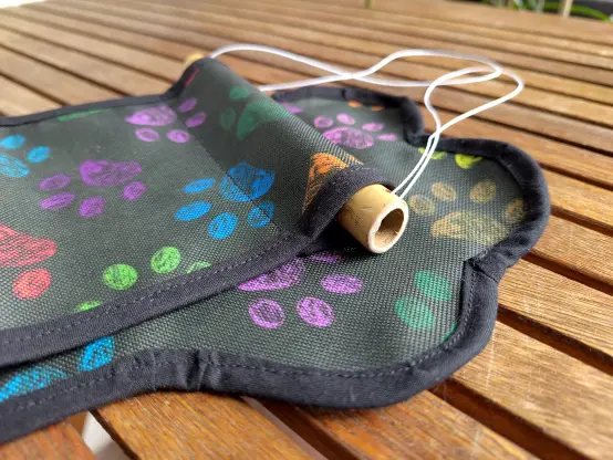 Close up of the top with a bamboo stick and white thread.