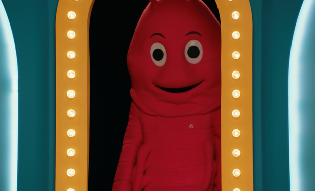 A lobster mascot stands in the threshold of the Game Changer set doorway.