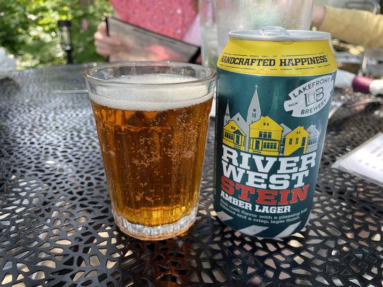 A can and glass of amber lager