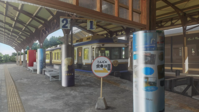 A blue train is at a platform