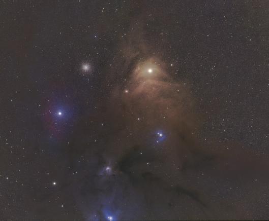 Astronomical image showing the Antares region in the night sky, featuring bright stars, dark dust clouds, and nebulae.
